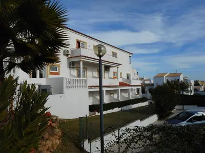 a white building with a street light in front of it at Agua Marinha ROSA- Hotel in Albufeira