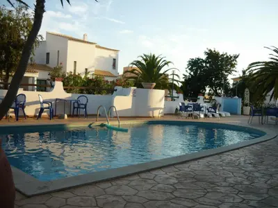 a swimming pool in the middle of a resort at Agua Marinha ROSA- Hotel in Albufeira