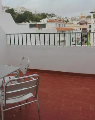 a bed with a white pillow and a wooden headboard at Vegas Residence - Adults Only in Albufeira