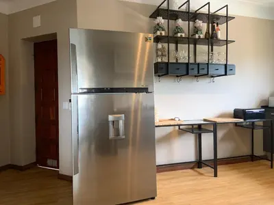 a stainless steel refrigerator in a kitchen with a counter at Cegonha Villa powered by Cegonha Resort- Private swimming pool & air con in Albufeira