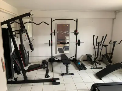 a gym with several exercise equipment in a room at Cegonha Villa powered by Cegonha Resort- Private swimming pool & air con in Albufeira