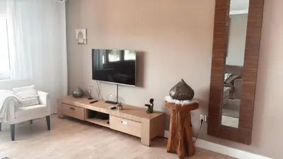 a living room with a tv and a mirror at Cegonha Villa powered by Cegonha Resort- Private swimming pool & air con in Albufeira