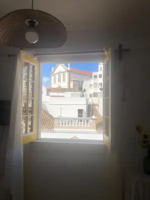 an open window with a view of a building at Maria Guest house in Albufeira