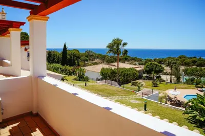 a balcony with a view of the ocean at Moradias Villas Rufino in Albufeira