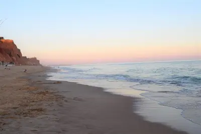 a sandy beach with the ocean in the background at Ritta's house in Albufeira