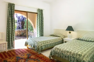 a hotel room with two beds and a window at Lageado Park in Albufeira