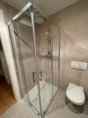 a shower stall with a toilet in a bathroom at Boa Vida in Quarteira
