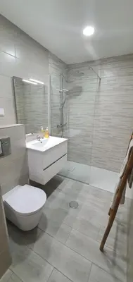a bathroom with a toilet and a sink and a shower at ACR Holiday Apartment in Quarteira