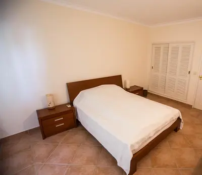 a bedroom with a bed and two night stands at Casa das Flores in Vale do Lobo