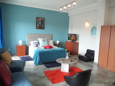 a bedroom with a bed and a table and chairs at Vivenda Luz - Jacuzzi & Swimming Pool in Albufeira