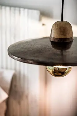 a lamp hanging from a table in a room at Lemon Tree Stay in Faro