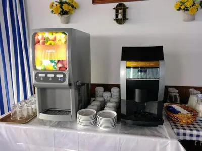 a counter with a coffee maker and a coffee machine at Hotel da Gale in Albufeira