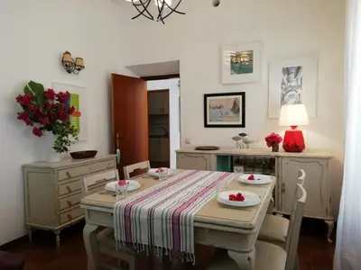 a dining room with a table and chairs with flowers on it at Casa da Guida in Albufeira