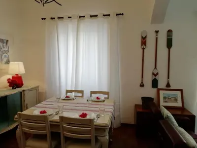 a dining room with a table and chairs and a window at Casa da Guida in Albufeira