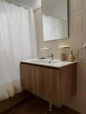 a bathroom with a sink and a mirror at Casa da Guida in Albufeira