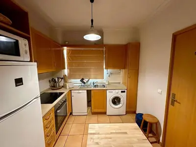 a kitchen with a white refrigerator and a dishwasher at Monteverde Kulle by FHR piscina & parking in Vilamoura