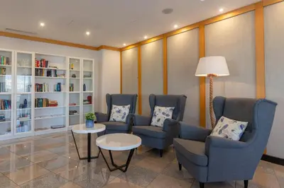 a waiting room with three chairs and a table at The Navigator - Solaqua in Albufeira