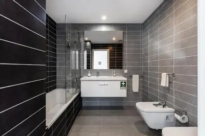 a bathroom with a toilet and a sink and a mirror at Design Villa Pascoal in Albufeira