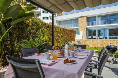 a table with food and drinks on a patio at Design Villa Pascoal in Albufeira