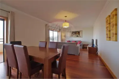 a dining room and living room with a table and chairs at Corcovada, Albufeira, Algarve in Albufeira