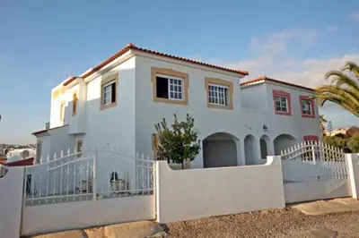 a large white house with a white fence at Villa V4 com Piscina Privada a 400 metros da Praia in Albufeira