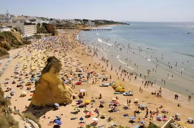 a crowd of people on a crowded beach at Spacious house with private pool in Albufeira in Albufeira