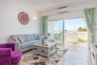 a living room with a couch and a table at Camilla apartment in Albufeira