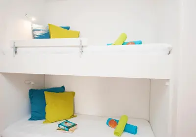 two bunk beds with yellow and blue pillows at Apartment Marbella by Algarve Vacation in Albufeira