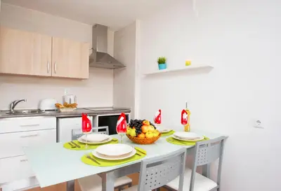 a kitchen with a table with a bowl of fruit on it at Apartment Marbella by Algarve Vacation in Albufeira
