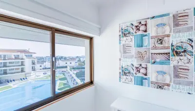 a window in a room with a view of a city at Stay Inn Albufeira - 303B Apartment in Albufeira