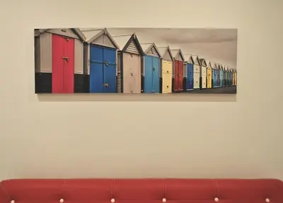 a painting of colorful beach huts on a wall at Stay Inn Albufeira - 303B Apartment in Albufeira