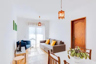 a living room with a couch and a table at AL - Apartamento Girassol in Quarteira