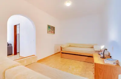 a living room with a couch and a table at AL - Apartamento Girassol in Quarteira
