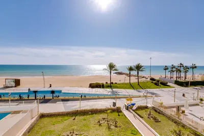 a view of the beach and a swimming pool at AL - Apartamento Girassol in Quarteira