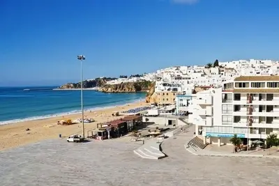 a view of a beach with buildings and the ocean at Apartamentos Edificio Albufeira - Alojamento Local in Albufeira