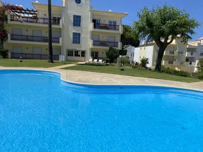a large blue swimming pool in front of a building at Bogart at Casablanca by OCvillas in Albufeira
