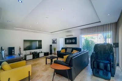 a living room with two couches and a tv at villa Aqua-Jacuzzi-heatable pool-sauna-gym-snooker in Albufeira