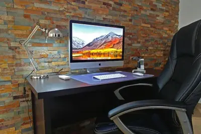 a computer monitor sitting on a desk with a chair at villa Aqua-Jacuzzi-heatable pool-sauna-gym-snooker in Albufeira