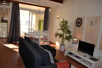 a living room with a couch and a tv at TP MARINA 27, Vilamoura View Apartment in Quarteira