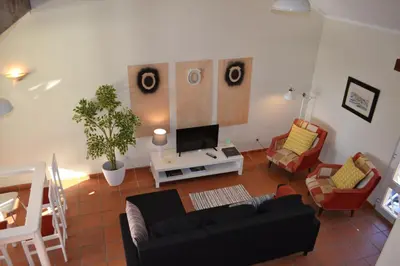 a living room with a couch and a tv at TP MARINA 27, Vilamoura View Apartment in Quarteira