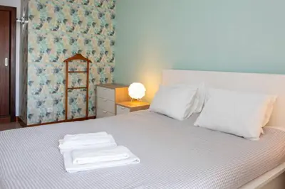 a bedroom with a bed with towels on it at The Albufeira Concierge - Modern Salgados in Albufeira