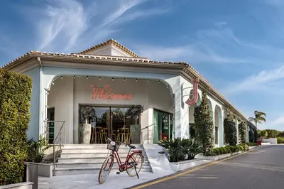 a red bike parked in front of a store at The Magnolia Hotel in Quinta do Lago