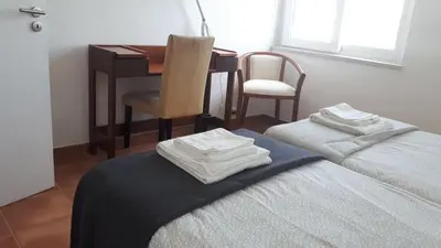 a bedroom with a table and a bed with towels on it at Hello Sun in Vilamoura