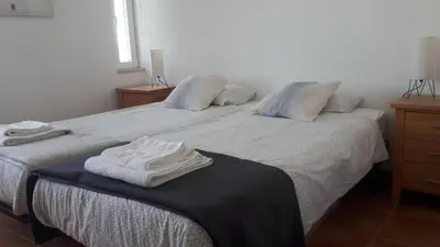 a bedroom with two beds with towels on them at Hello Sun in Vilamoura