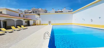 a swimming pool in the middle of a building at Falesia Beach Apartment in Albufeira