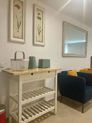 a room with a table and a blue chair at Bayview Apartment 213 in Albufeira