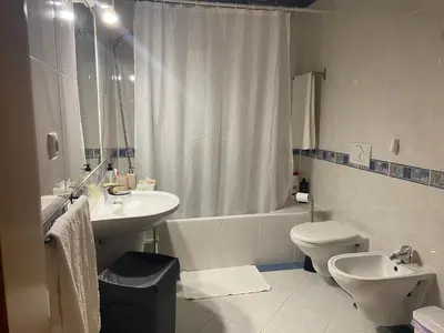 a bathroom with a sink and a toilet and a shower at Nice apartment near Faro's airport in Faro