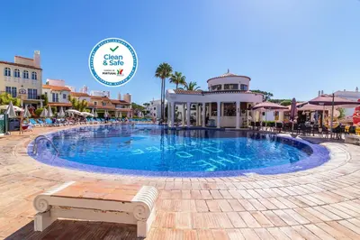 a pool at a resort with a sign that says ocean reef resorts at The Old Village, Prestige and Solar by Village 4U in Vilamoura