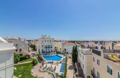 an apartment with a swimming pool and buildings at The Old Village, Prestige and Solar by Village 4U in Vilamoura