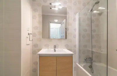 a bathroom with a sink and a mirror and a tub at The Old Village, Prestige and Solar by Village 4U in Vilamoura